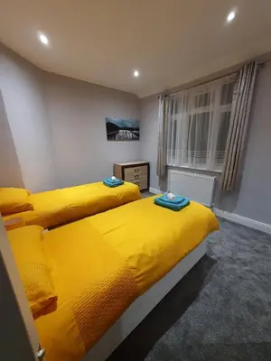 two beds sitting next to each other in a bedroom at Breeze on Southend in Essex in Southend-on-Sea