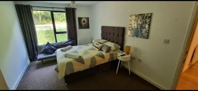 a bedroom with a bed and a window at 360 Serviced Accommodations - Brentwood 2 Bedroom Executive Apartment with Secure Parking in Brentwood