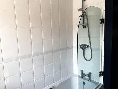 a bathroom with a shower and a sink and a tub at Toothbrush Apartments - Central Ipswich - Nr Train Station in Ipswich
