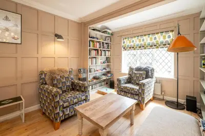 a living room with two chairs and a table at 1 Westgate in Thorpeness