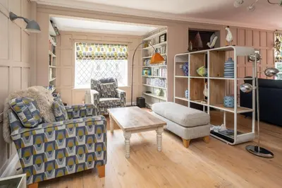a living room with a couch and a table at 1 Westgate in Thorpeness