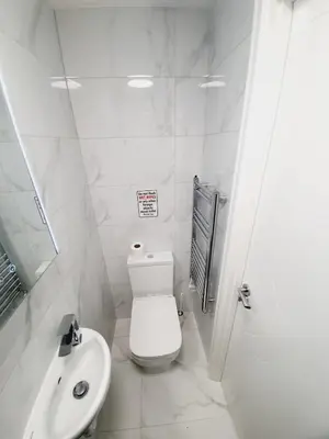 a white bathroom with a toilet and a sink at Southend on Sea - Westcliff Studios - Great Location in Southend-on-Sea