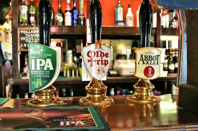 a group of three wine bottles on a bar at The White Horse in Beyton