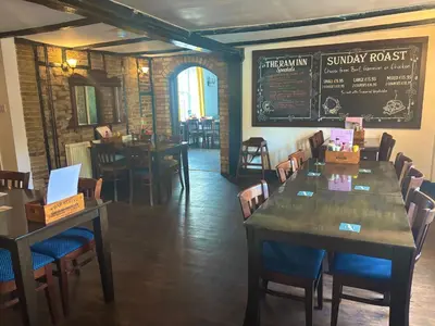 a dining room with tables and chairs and a chalkboard at The Ram Inn in Brandon