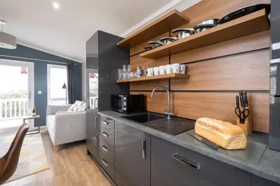 a kitchen with a sink and a counter top at Savannah Lodge - Aldeburgh Coastal Cottages in Sizewell