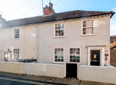 a white house on a street at Admiral Cottage in Aldeburgh