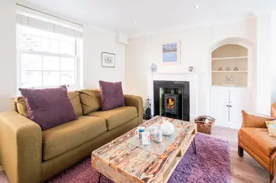 a living room with a couch and a coffee table at Admiral Cottage in Aldeburgh