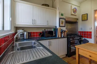 a kitchen with a sink and a stove at Beach House - Aldeburgh Coastal Cottages in Aldeburgh