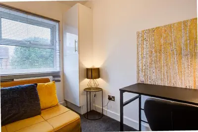 a living room with a couch and a table and a window at Free Parking Business Stay Office Fast WiFi in Colchester
