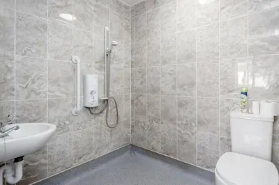 a bathroom with a toilet and a sink at Remaj Serviced Accommodation, sleeps 7 & free parking in Laindon