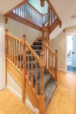 a staircase in a home with wooden railings at 6 Lakeside Avenue in Thorpeness