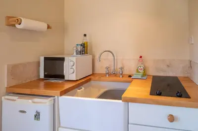 a kitchen with a sink and a microwave at 6 Lakeside Avenue in Thorpeness