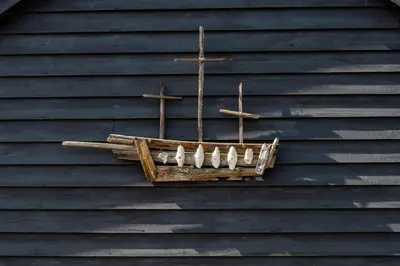a cross hanging on the wall of a building at The Stables, Theberton in Theberton