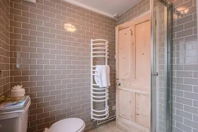 a bathroom with a toilet and a glass shower at 6 West Lane in Aldeburgh - Beautiful cottage near high street in Aldeburgh
