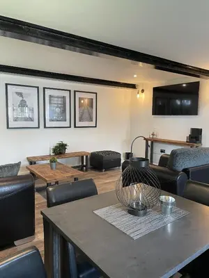 a living room with a table and chairs at Booking Urban Halstead in Halstead