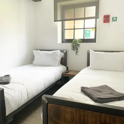 two beds sitting next to each other in a room at Booking Urban Halstead in Halstead