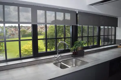 a kitchen with a sink and a window overlooking a yard at Booking Urban Halstead in Halstead