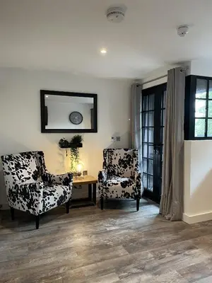 a living room with two chairs and a table at Booking Urban Halstead in Halstead