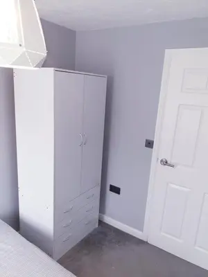 a bedroom with white cabinets and a white door at Elegant 2 BR Apartment in Historic Cambridge in Papworth Everard