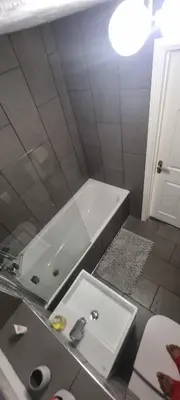 a bathroom with a white tub and a sink at Elegant 2 BR Apartment in Historic Cambridge in Papworth Everard