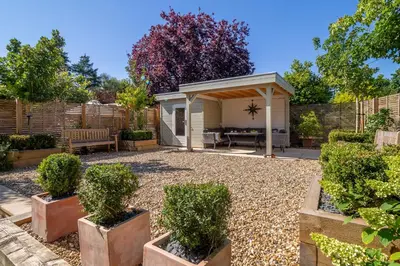 a garden with a gazebo and a patio at Yew Tree Cottage in Westleton