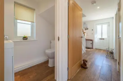 a bathroom with a toilet and a window at Yew Tree Cottage in Westleton