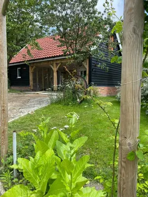 a house with a yard with green plants at Foxgloves self catering in Westleton