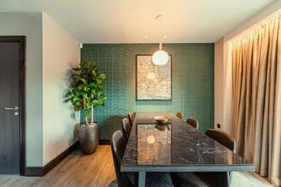 a dining room with a table and chairs at The Fellows House Mews in Cambridge