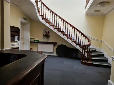 a hallway with a staircase in a house at Queen Suite in Ipswich