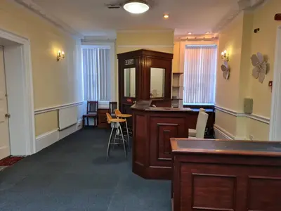 a room with a bar in the middle of a room at Borough Studio in Ipswich