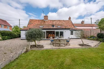 a house with a table and chairs in a yard at Lavender Cottage, Middleton in Saxmundham