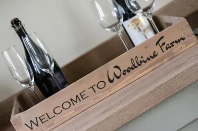 a wooden tray with glasses and wine bottles on a table at 2 Bed in Weybread oc-tclwey in Needham