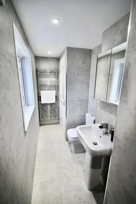 a bathroom with a sink and a toilet at Mill House Townhouse in Newmarket