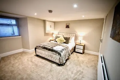 a bedroom with a bed and a window at Mill House Townhouse in Newmarket
