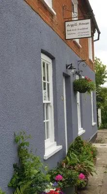 a blue house with flowers in front of it at Argyll House Bed and Breakfast in Westleton