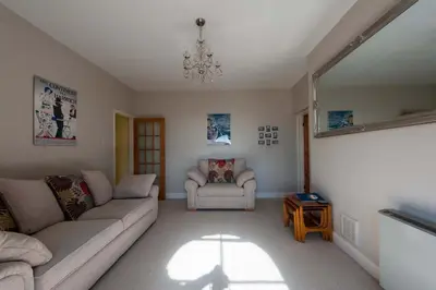 a living room with a couch and a chair at The Lookout Penthouse in Harwich