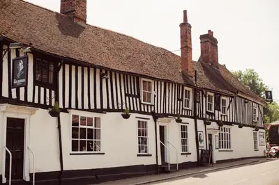 a black and white building on the side of a street at The Marlborough Dedham in Dedham