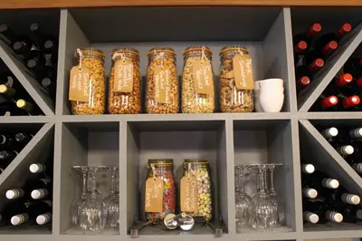a bunch of jars of food in a wine cellar at The Marlborough Dedham in Dedham