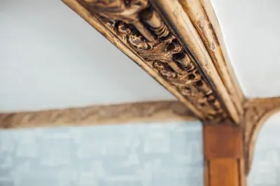 an antique mirror with a wooden frame on a table at The Marlborough Dedham in Dedham