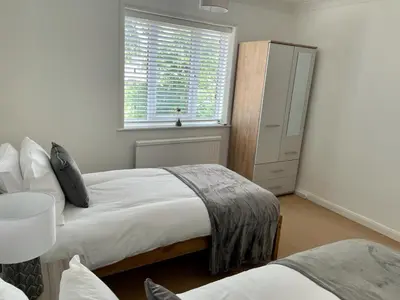 a bedroom with two beds and a window at Number 15 in Norwich