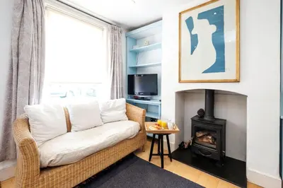 a living room with a couch and a fireplace at 201 High Street in Aldeburgh