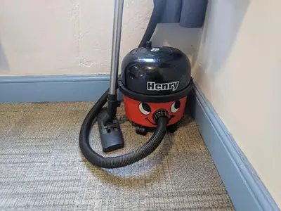 a vacuum cleaner with a hose attached to a wall at HARLOW INTERNATIONAL HOSTEL in Harlow