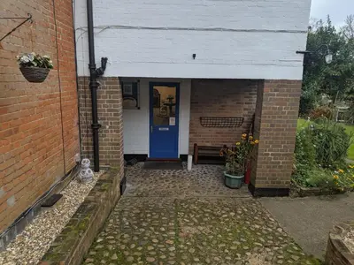 an entrance to a brick house with a blue door at HARLOW INTERNATIONAL HOSTEL in Harlow