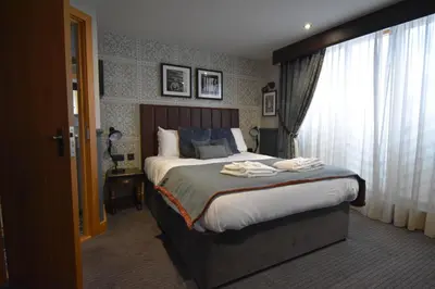 a bedroom with a bed with towels on it at Guinness Arms in Icklingham