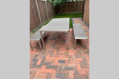 two benches sitting on a brick patio at The Bungalow in Chesterton