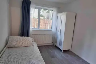 a bedroom with a bed and a dresser and a window at The Bungalow in Chesterton