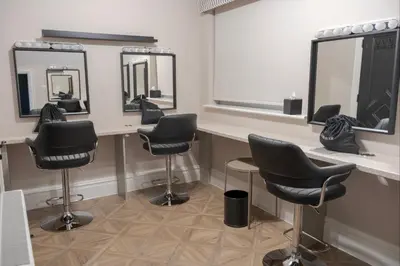 a hair salon with four barber chairs and mirrors at The Kings Head in Chelmsford