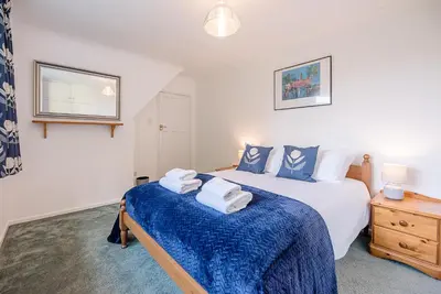 a bedroom with a bed with towels on it at The Spinney Saxtead nr Framlingham in Woodbridge