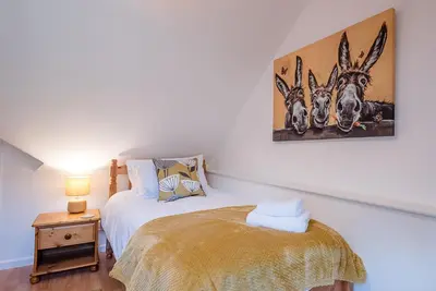 a bedroom with a bed and a picture of three antelope at The Spinney Saxtead nr Framlingham in Woodbridge
