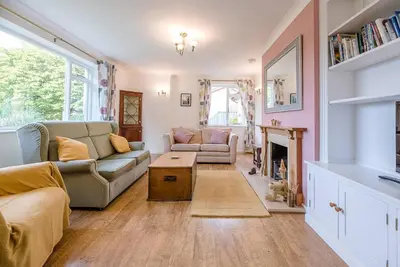 a living room with a couch and a fireplace at The Spinney Saxtead nr Framlingham in Woodbridge